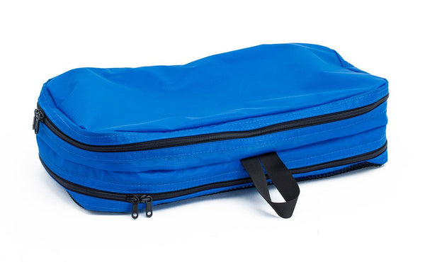 An empty and zipped closed Island (blue) Aether Small Laundry Aeronaut 45 Packing Cube all-fabric side up.
